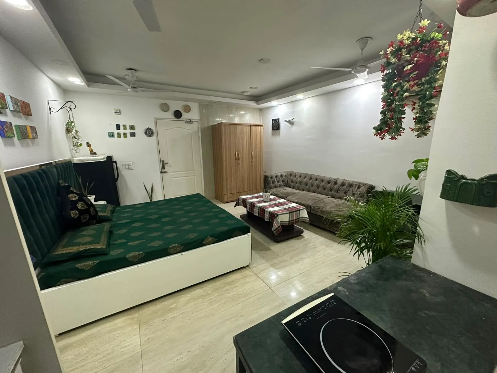 Furnished studio with bed, seating and kitchenette