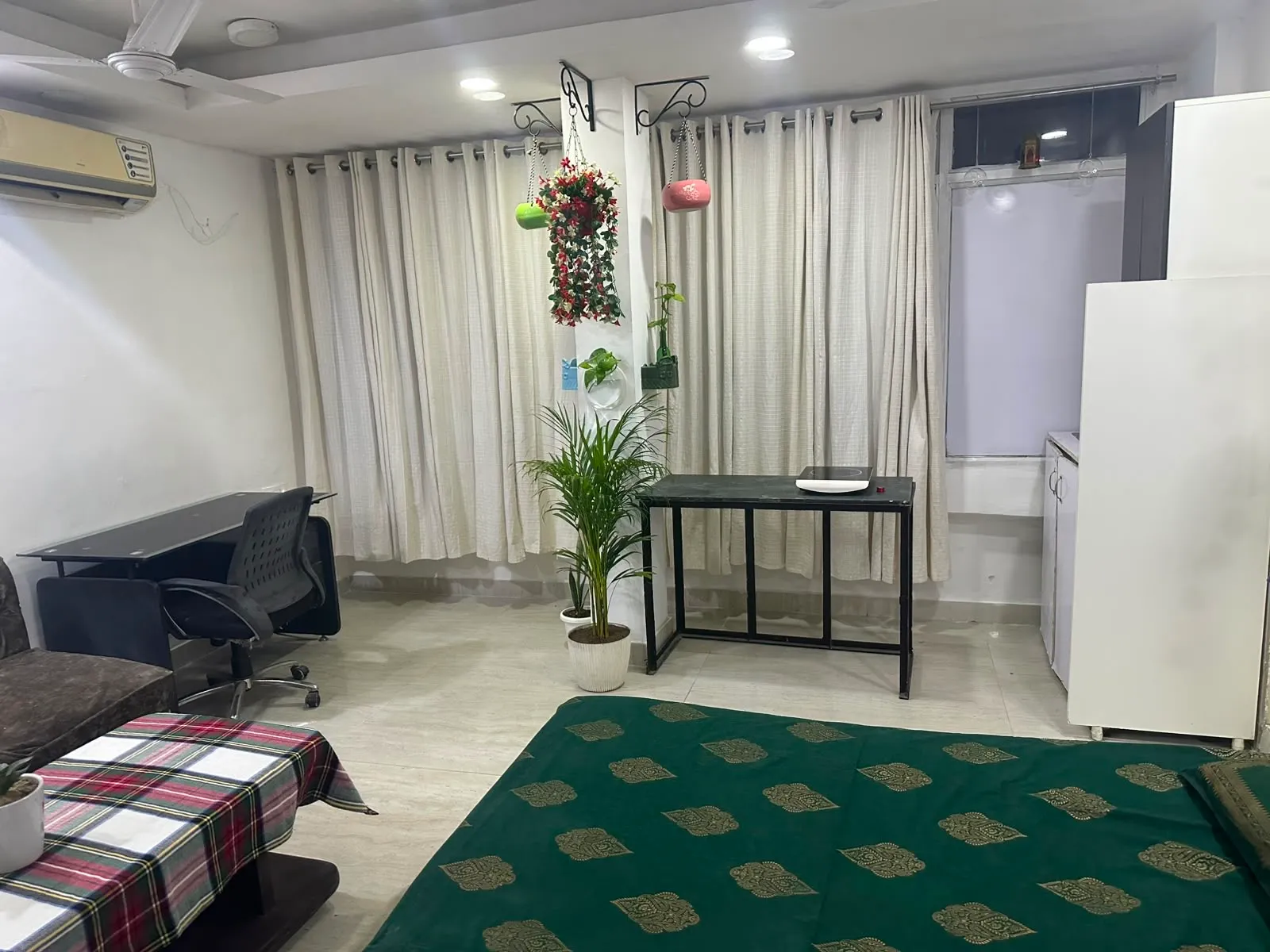 Curtained windows with the workspace and rug